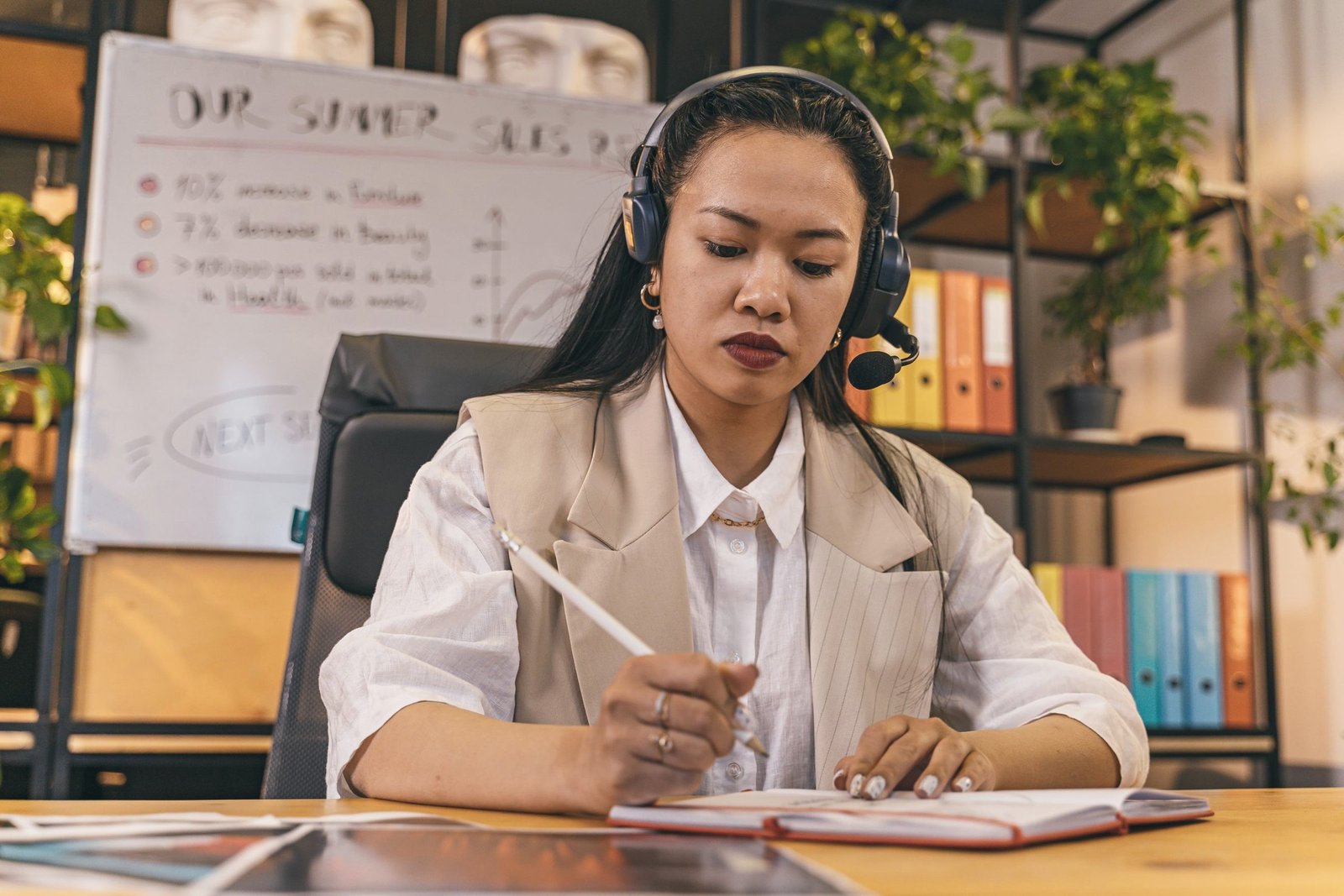 Linguist with headset post-editing and taking notes