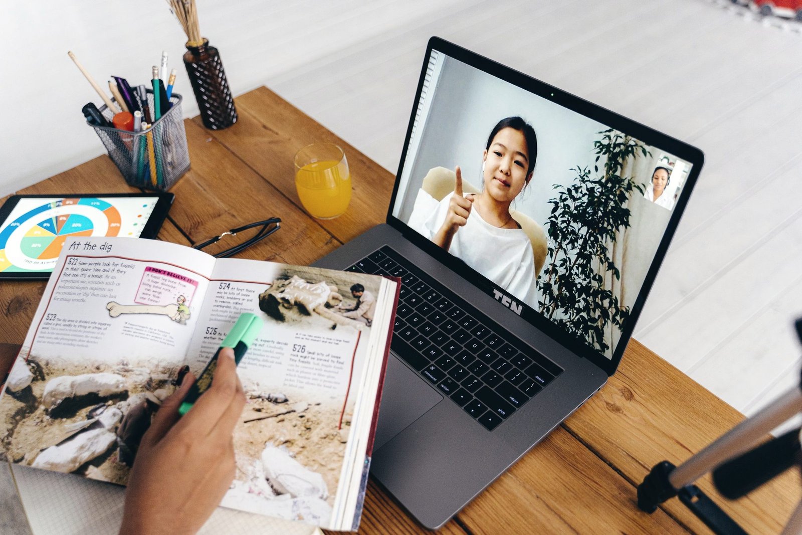 Content on a laptop next to printed material