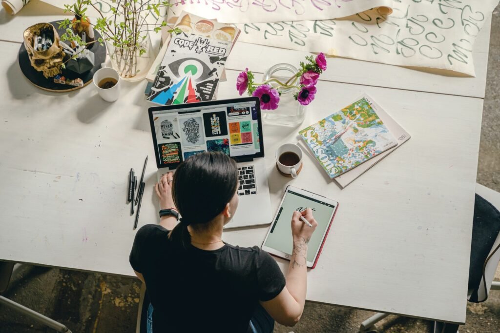 Copywriter working on layouts at a laptop
