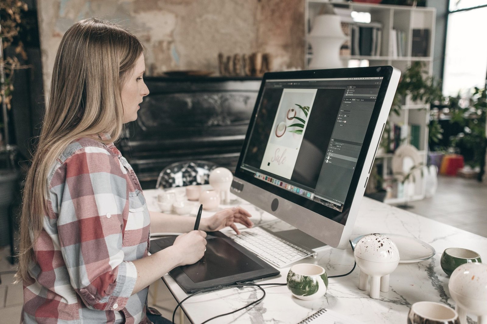 Designers working on a layout at a large screen